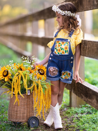 Girls Summer set features a yellow ruffle sleeve top with white polka dots and denim overall shorts with sunflower print and sequin mesh patches - 2T-10Y