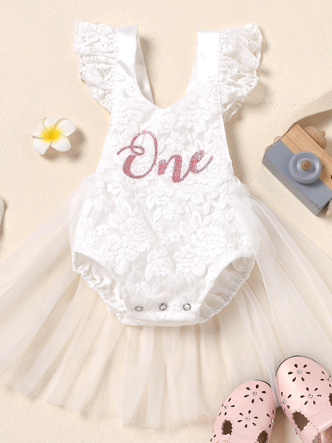 Baby lace overall onesie that ties at the back with tulle train, little ruffles at the shoulder, and a gold "One" printed on the bodice