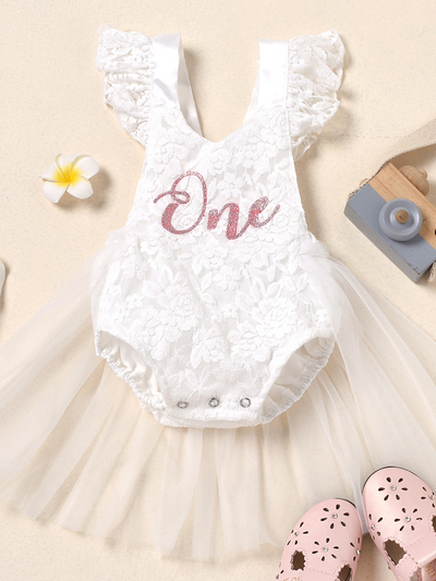 Baby lace overall onesie that ties at the back with tulle train, little ruffles at the shoulder, and a gold "One" printed on the bodice