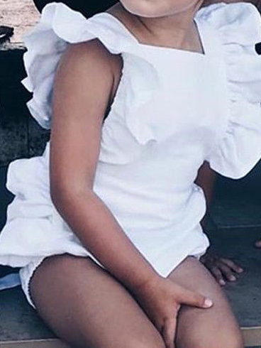 Baby onesie has cute little shoulder ruffles and ruffles on the side. Overall style with strap closure at the back White