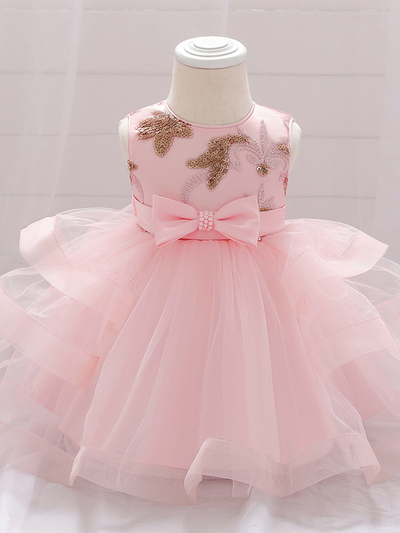 Baby princess dress has a satin bodice with sequin applique, a bow belt at the waist, and a layered tulle skirt 