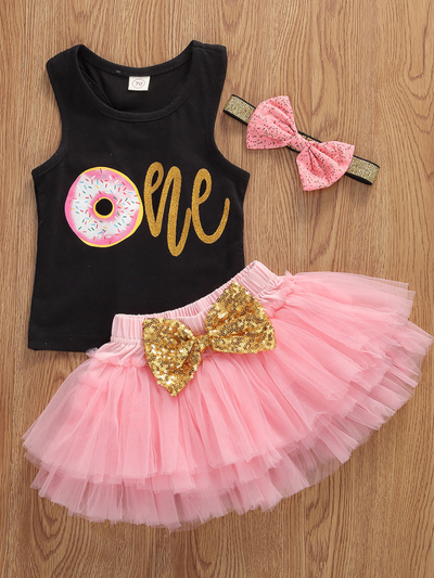 Baby set features a black top with a gold "One" print and a pink tutu skirt with a sequin bow at the waist. Comes with a matching sequin headband