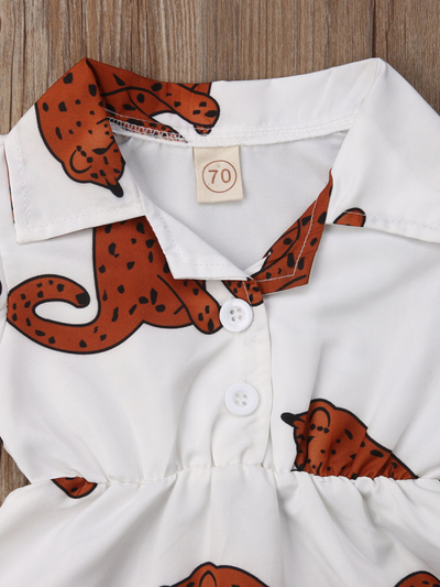 Baby white onesie with leopards printed has ruffled short sleeves and a cute collar. Front button and elastic waist.