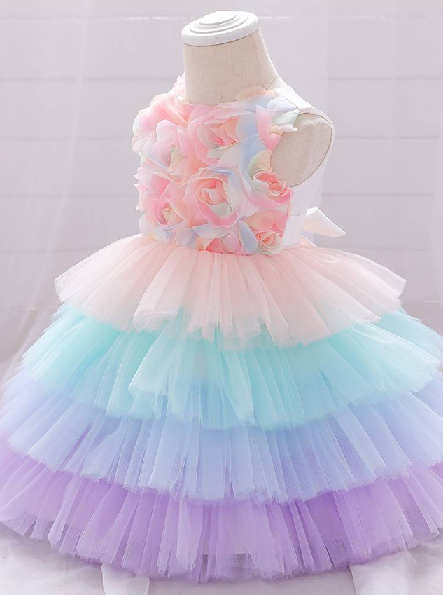 Baby Spring tulle dress' bodice has a delicate flower applique in tulle, has a multicolor layered skirt and bow at the back