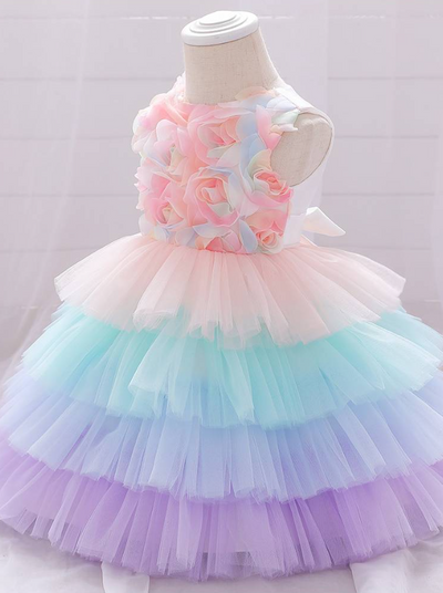 Baby Spring tulle dress' bodice has a delicate flower applique in tulle, has a multicolor layered skirt and bow at the back