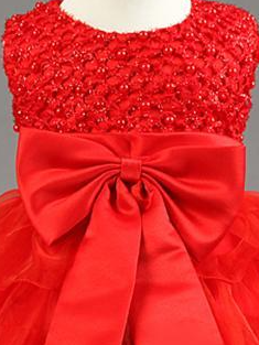 Baby tulle dress bodice has a delicate pearl detail with a bow at the waistline and a multilayer tulle skirt