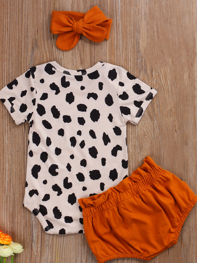Baby set features a short-sleeved onesie with animal print, bloomer shorts with a bow, and matching headbands