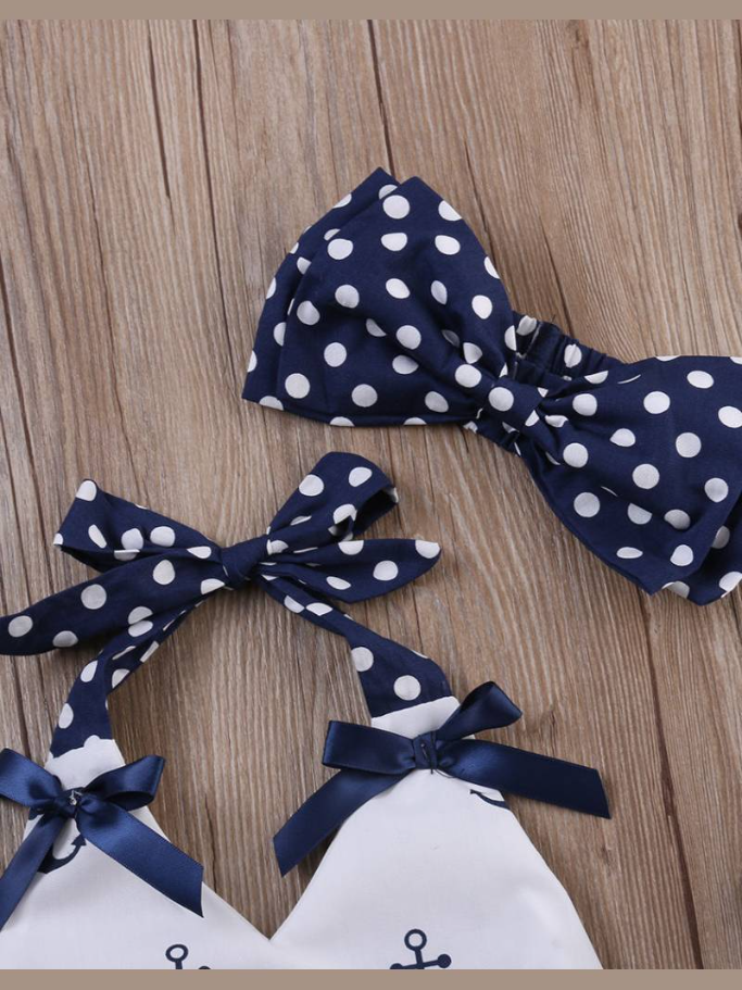 Baby set features a white halter top with an anchor print and adjustable straps with polka dot bloomer shorts