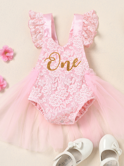 Baby lace overall onesie that ties at the back with tulle train, little ruffles at the shoulder, and a gold "One" printed on the bodice