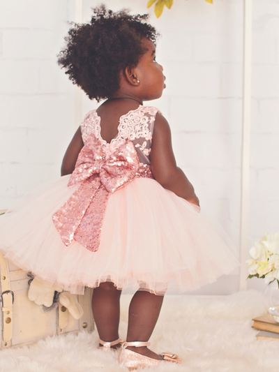 Baby tutu dress has an embroidered floral bodice, a sequin belt at the waistline with a big bow at the back, and a tutu skirt