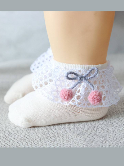 Baby socks with crochet and pompom details
