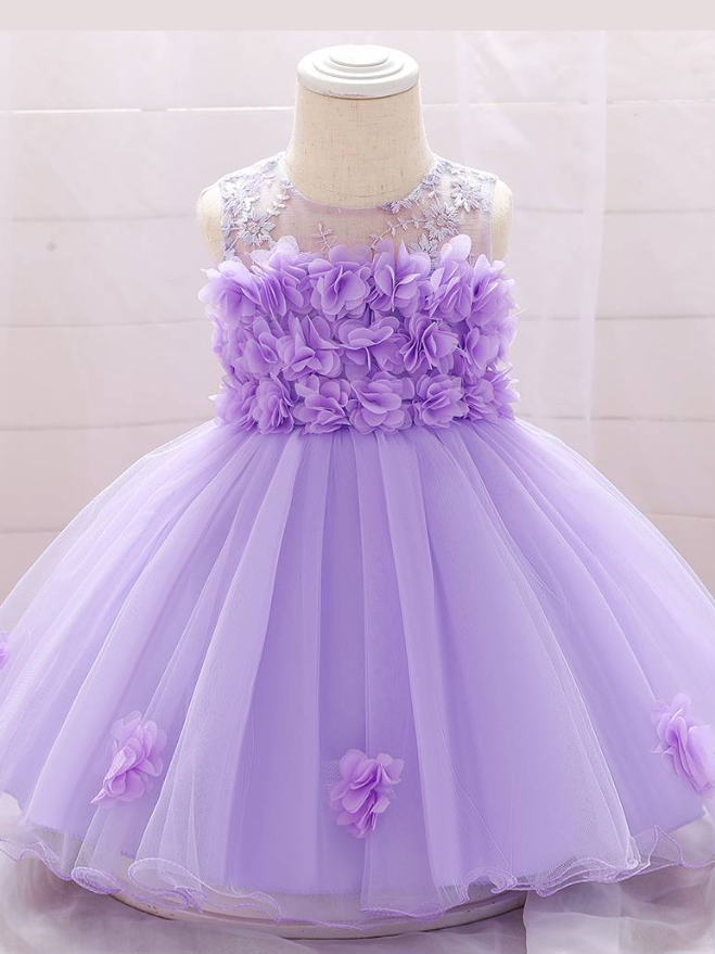 The dress has a bodice with flower applique and tulle skirt