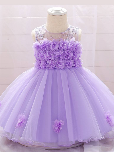 The dress has a bodice with flower applique and tulle skirt