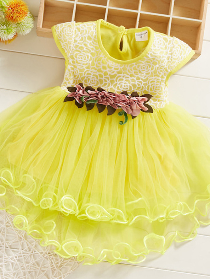 Baby Spring dress has an embroidered bodice, applique flowers at the waistline, and a hi-lo tulle skirt