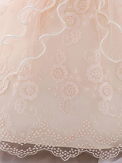 Baby dress has a tulle overlay with a multi-layer skirt, bow detail at the waist-