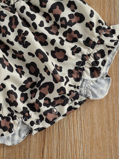 Baby onesie with a stretchy bodice with adjustable shoulder straps with matching headband