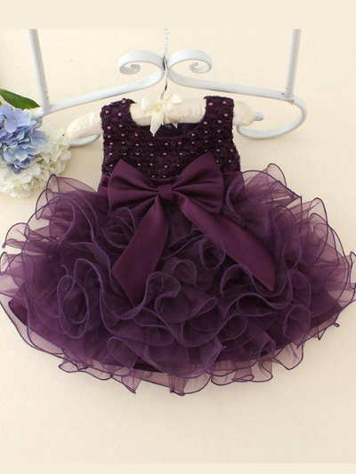 Baby tulle dress bodice has a delicate pearl detail with a bow at the waistline and a multilayer tulle skirt