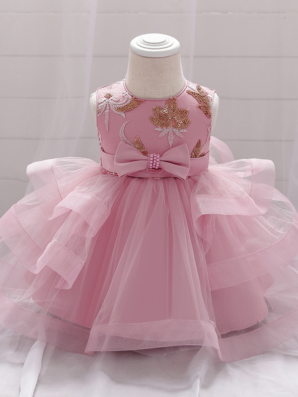 Baby princess dress has a satin bodice with sequin applique, a bow belt at the waist, and a layered tulle skirt