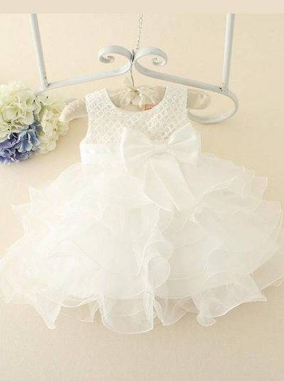 Baby tulle dress bodice has a delicate pearl detail with a bow at the waistline and a multilayer tulle skirt