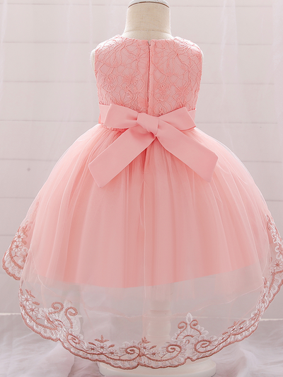 Baby dress has embroidered tulle overlay bodice and hi-lo tulle overlay skirt, removable big bow accent at the back and flower applique at the front