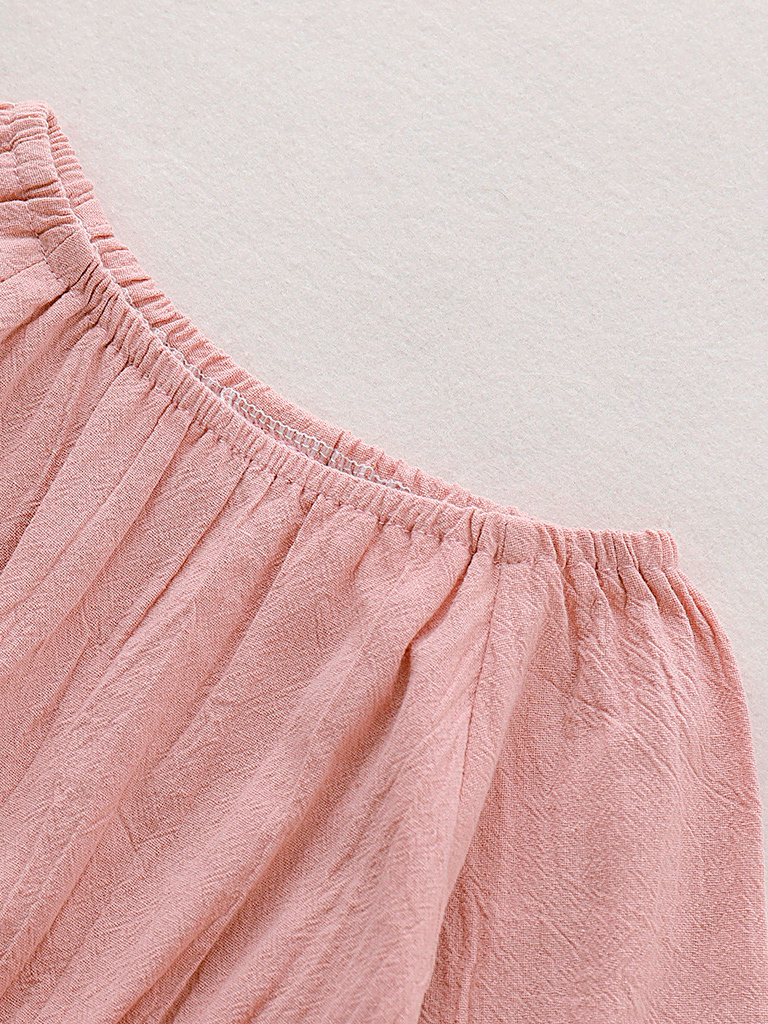 Baby boho style onesie has ruffled long sleeves and a cute bow at the front